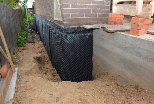 Happy homeowners after waterproofing job in Northport